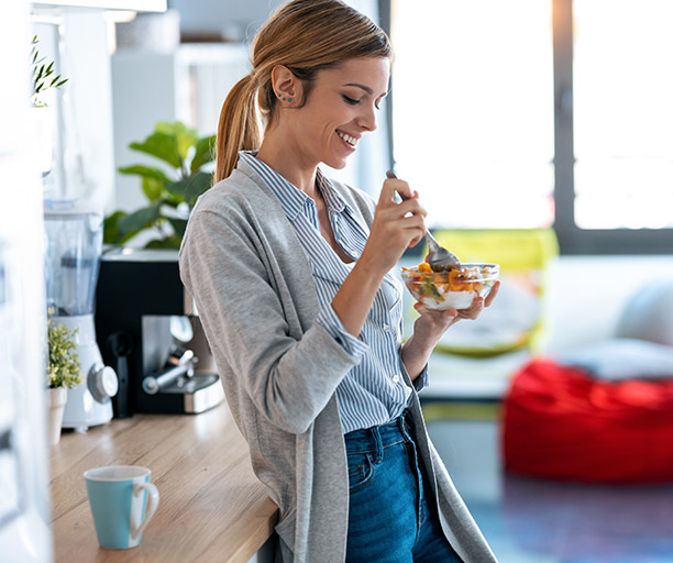 Person eating fruit and dairy.