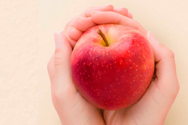 person holding apple